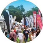 Exhibitor stalls and flags at Canberra Caravan Camping Lifestyle Expo