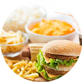 Selection of food including a burger, chips and other assortments.