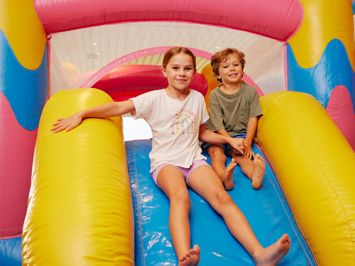 Two children posing on a jumping castle