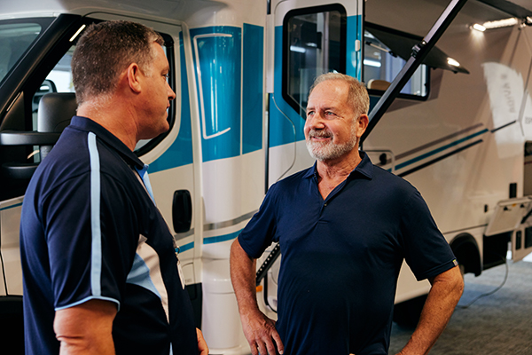 Customer talking to an exhibitor sales person at the Caravan Expo.